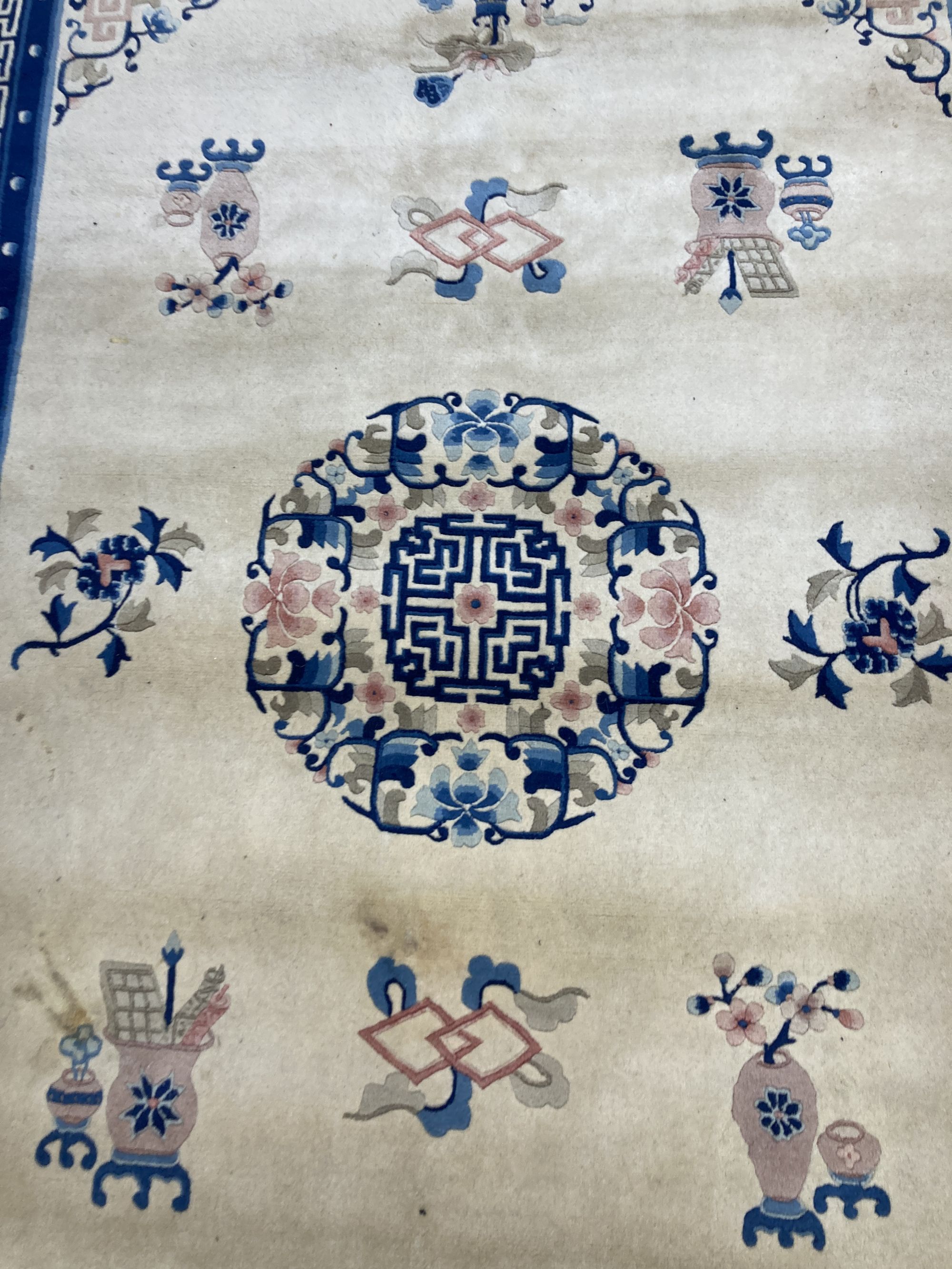 A Chinese wool cream ground rug,